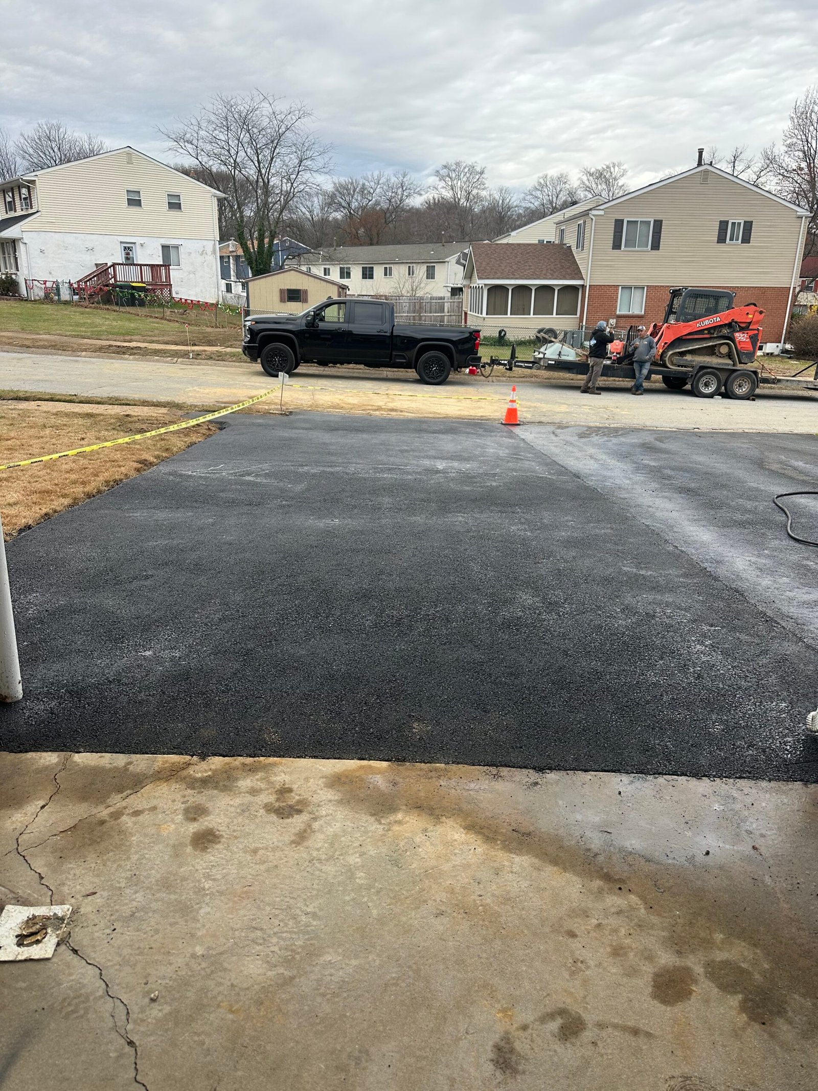 Parking area asphalt resurfacing with new striping
